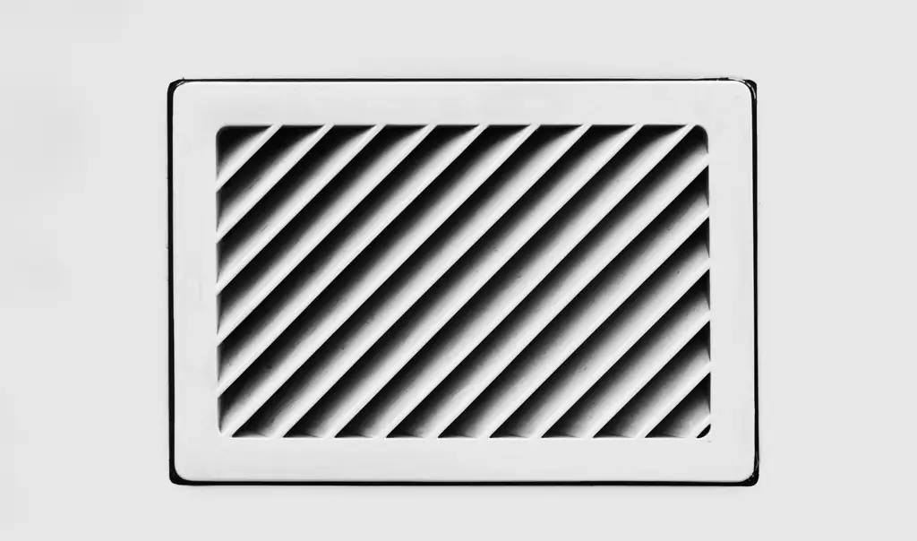 White wall air vent with angled louvers
